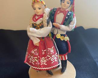 a set of handmade Polish folk art dolls, likely representing the traditional regional costumes of Krakow, Poland.