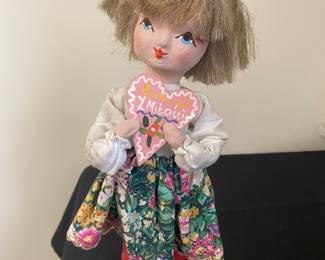 vintage handmade Polish folk art doll. She is holding a heart that says "Z Miłości" in Polish.