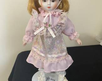 porcelain doll appears to be from the Heritage Mint Collection.
