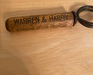 vintage wood-handled pocket corkscrew with advertising for "Warren & Hardy Whiskies Wines Brandies" in Batesville, Arkansas.
