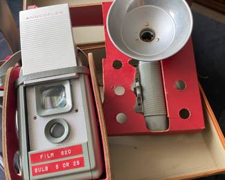 a vintage Anscoflex II camera with its accompanying flash attachment, both housed in their original case.
The camera was manufactured by Ansco in the USA around 1954-1956 and designed by the industrial designer Raymond Loewy.