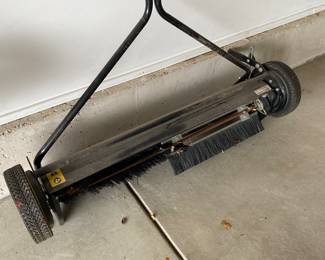 an Agri-Fab tow-behind lawn sweeper.