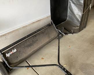 an Agri-Fab tow-behind lawn sweeper.