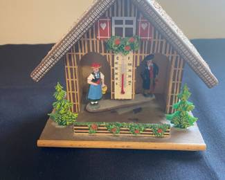 a vintage Toggili German Black Forest weather house, a functional weather predictor and collectible item.