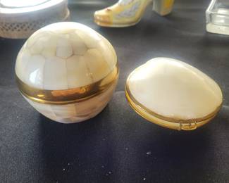 a small spherical box in bronze covered with mother-of-pearl.