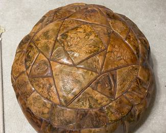 handmade Moroccan leather pouf or ottoman with an embossed patchwork design.
