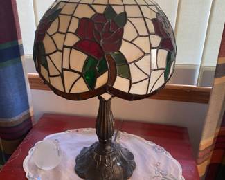Tiffany-style stained glass table lamp with a red rose pattern.