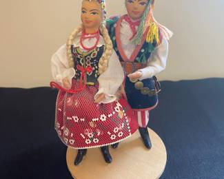 a pair of vintage, handmade Polish folk dolls. These collectibles are dressed in authentic regional attire
