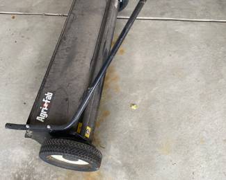 an Agri-Fab tow-behind lawn sweeper.