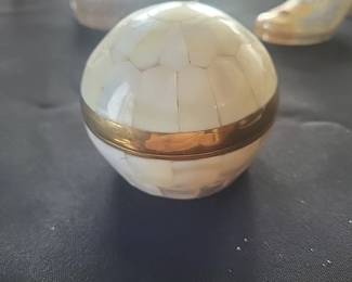 a small spherical box in bronze covered with mother-of-pearl. Polished Clam shell Trinket box with Brass trim and Clasp