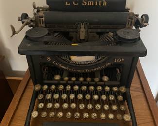 an L.C. Smith & Corona desktop typewriter. the design, with round glass keys and black enamel finish, is characteristic of models produced in the 1920s and 1930s.