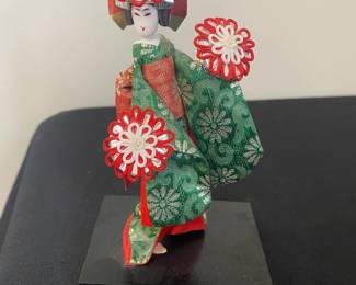 a vintage Japanese geisha or maiko doll, often associated with the traditional "Seven Hat Dance"
