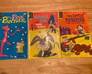 vintage comic books from the 1970s, featuring classic cartoon characters.
Left: The Pink Panther comic, published by Gold Key.
Middle: Yosemite Sam and Bugs Bunny comic, published by Gold Key.
Right: The Little Monsters comic, published by Gold Key.