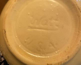 vintage Watt Pottery items in the highly collectible Starflower pattern. a pitcher and a covered cookie jar or canister, feature a hand-painted design of red, five-petal flowers and green leaves on a creamy yellow base.