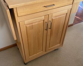 Wood butcher block kitchen cart with drop leaf in a natural finish