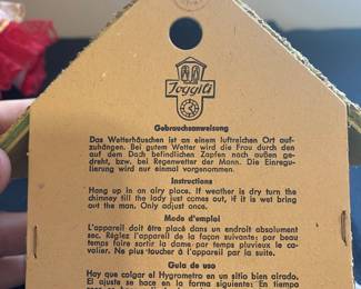 a vintage Toggili German Black Forest weather house, a functional weather predictor and collectible item.