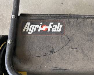 an Agri-Fab tow-behind lawn sweeper.
