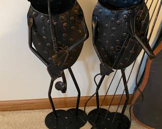 Pair of vintage tin metal frog musicians garden ornaments, with one playing a saxophone and the other a cello