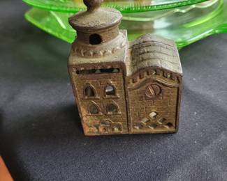 an antique cast iron still bank, commonly known as a "Domed Mosque" or "3-Story Mosque" bank.
It was manufactured by the A.C. Williams Company of Ravenna, Ohio, primarily in the 1920s.