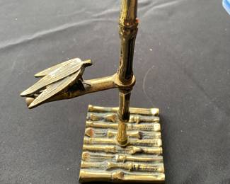 a vintage brass bamboo memo or card holder.
It features a Victorian style design with a bamboo motif. The item has three tiered clips for holding notes, business cards, or photos.