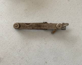 a vintage spark plug gap gauge and adjusting tool.