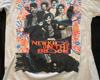 a vintage 1990 New Kids On The Block T-shirt featuring a group photo of the band members. size med 38-40