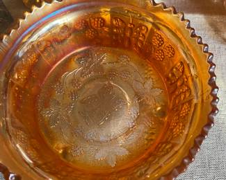 Fenton marigold carnival glass bowl in the Butterfly and Berry pattern with a sawtooth edge