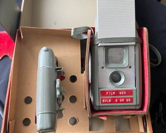 an Anscoflex II vintage box camera in its original case with the flash unit. It is a pseudo Twin Lens Reflex (TLR) camera designed by Raymond Loewy and manufactured by Ansco in the USA from around 1954-1956