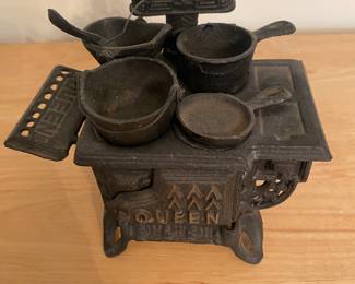 an Old Mountain cast iron miniature "Queen" box stove set, which is a replica of traditional stoves from the 19th century.