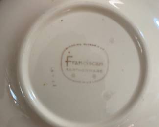 set of Franciscan Apple pattern dinnerware.
The pattern was first introduced in 1940 and features hand-painted red apples, green leaves, and brown branches on a creamy off-white earthenware background.