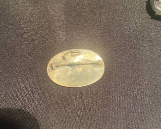 vintage Taxco Mexican sterling silver brooch with a crushed stone inlay and mixed-metal figure.