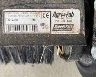 an Agri-Fab tow-behind lawn sweeper.