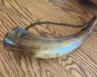 a powder horn, used historically to carry gunpowder for firearms.