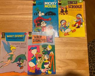 vintage Walt Disney comic books, specifically a collection of Mickey Mouse and Goofy, Uncle Scrooge, Walt Disney Showcase, and Walt Disney's Comics and Stories issues.