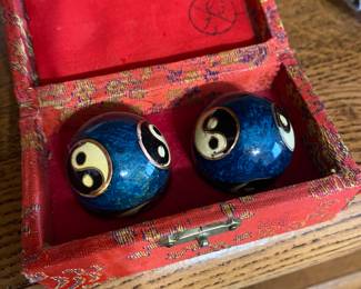 vintage Chinese Baoding balls with a blue Yin Yang design, presented in a red fabric-lined box.