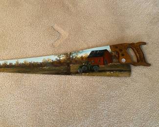 a hand-painted antique or vintage hand saw, a piece of folk art used as rustic home decor.