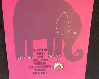 an art print or greeting card featuring a dark pink elephant illustration on a bright pink background. The text in the image is a quote that reads, "THINGS LOOK DIFFERENT WHEN YOU'RE SIDE DOWN"