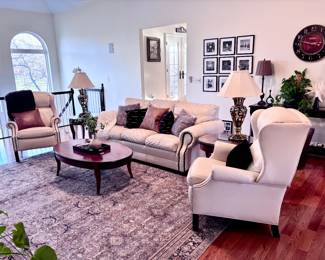 Cream Leather Sofa, Two Reclining Chairs, Area Rug, Two Brass Stiffel Lamps, Coffee Table, End Tables and Décor