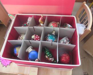 there are five bins of ornaments with 2 layers on the kitchen table