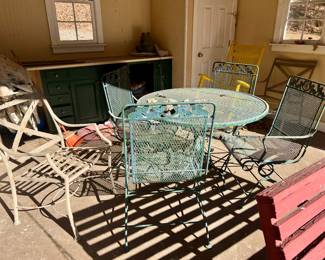 Outdoor furniture in the boat house on the pond including yellow rocking chair