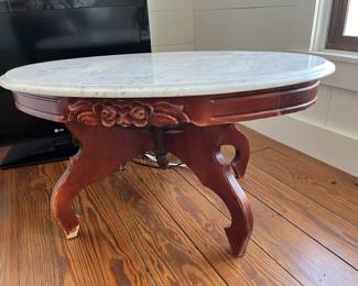 $60; Vintage Victorian-style low marble top table; approx. 17.5" x 33.5" x 22"; wear to base, crack to part of marble