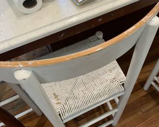 $125; Four painted counter-height rush seat bar chairs; approx. 24" seat, 38" back x 18" W. x 14 D.; wear from use