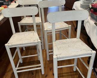 $125; Four painted counter-height rush seat bar chairs; approx. 24" seat, 38" back x 18" W. x 14 D.; wear from use