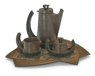 190
Salvador Terán (1920-1974, Mexican)
A glass mosaic inset brass coffee service, mid-20th century
Each marked to underside: Handwrought / Hecho en Mexico / Salvador / 408
Comprising a lidded coffee pot, a creamer, and a lidded sugar with spoon, all set on a tray with depressions for each vessel
4 pieces
Coffee: 8.75" H x 7.75" W x 4.375" D; Tray: 1" H x 16" W x 13.375" D
Estimate: $200 - $400