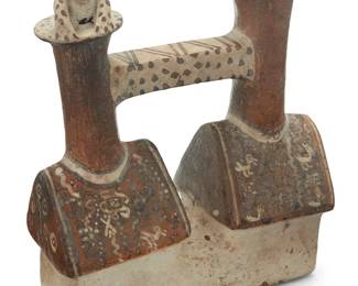 135
A Pre-Columbian style stirrup effigy vessel
20th century or earlier
With spout to one side and jaguar figure to the other, slip-painted with figural motifs and geometric patterns
7.5" H x 6.5" W x 2.875" D
Estimate: $200 - $400