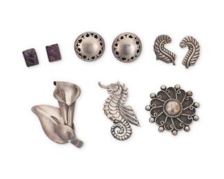 207
A group of Mexican silver jewelry
Mid-20th century
Variously marked: JE / Hecho en Mexico / 925 / Taxco / 980 / Sterling / Mexico / JC / Silver
Six works comprising three sterling silver brooches including a calla lily, a seahorse and a round filigree stylized floral pin, as well as three pairs of silver earrings including feathers, openwork shadowbox discs, and set amethyst rectangles
9 pieces
Largest brooch: 3.125" H x 2" W; Smallest: 2.125" Dia.; Earrings: 1.625" H to 0.625" H
90.9 grams gross
Estimate: $200 - $400
