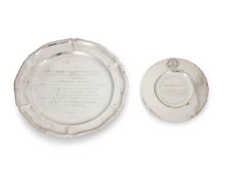 48
Two Mexican silver honorific trays
1971
Two works:

A Juventino Lopez Reyees tray with scalloped rim
Marked: JLR / Made in Mexico / [Eagle 9] / Sterling / 925 / 26; with retailer's label; inscribed: The American Club of Guatemala / To Our Friend and Fellow Member / The Honorable / Nathaniel Davis / Ambassador of the United States of America to the Republic of Guatemala Since November 17th 1968 / The Token of Our Recognition of His Outstanding Service to the Cause of American Guatemalan Friendship / August 18th 1971
10.875" Dia.

A Joyas Liscutin tray with a molded arrow-form element
Marked: 900 / Joyas Liscutin / Guatemala; inscribed: Al Excmo. Embajador de los E.E.U.U. / Sr. Nathaniel Davis / Con el Reconocimiento de la Cooperativa de Ahorro y Credito de Ciegos Unidos Santa Lucia R.L. / Guatemala 10 de Febrero de 1971
7" Dia.

2 pieces
Total weight: 17.17 oz. troy approximately
Estimate: $300 - $400