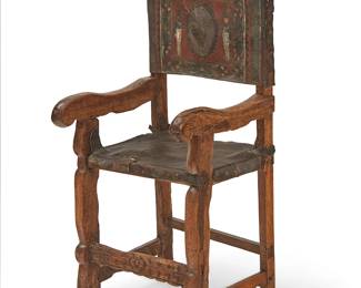 85
A Spanish Colonial Sillon de Frailero chair
17th/18th Century; Northern Andes Region
Likely Peruvian, the friar's chair with carved wood frame and tooled and painted leather seat and back, the back depicting a peacock within a wreath centering two soldier figures, all within a floral border
47.5" H x 21" W x 19" D
Estimate: $300 - $500