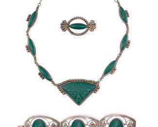 199
A group of Mexican silver and green glass jewelry
Mid/late 20th century
Variously stamped: FARFAN / 925 / Sterling / Hecho en Mexico / DF / Mexico
Comprising a set carved green glass mask necklace with set stone oval links and a similar design brooch, as well as an openwork filigree link bracelet with set carved green masks
3 pieces
Necklace: 21.5" L x 1.625" H; Bracelet: 7.25" L x 1.75" H; Brooch: 1.25" H x 2.25" W
140.2 grams gross
Estimate: $200 - $400