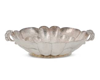 14
A Mexican sterling silver centerpiece bowl
Mid-20th century
Marked: Hecho en Mexico / La Esmeralda / 925 / 26888
With scalloped rim, lobed body, and opposed handles
3.75" H x 13.375" W x 8.25" D
31.41 oz. troy approximately
Estimate: $700 - $900